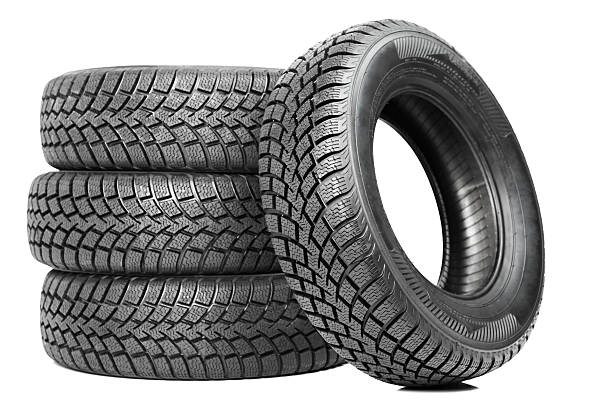 Stack of four black car tires isolated on white stock photo