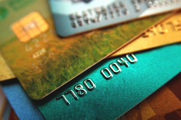 stack of multicolored credit cards, close up view stock photo