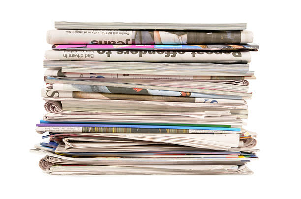 Stack of old newspapers and magazines on a white background stock photo
