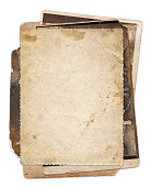 Stack of old vintage photos with stains and scratches background isolated