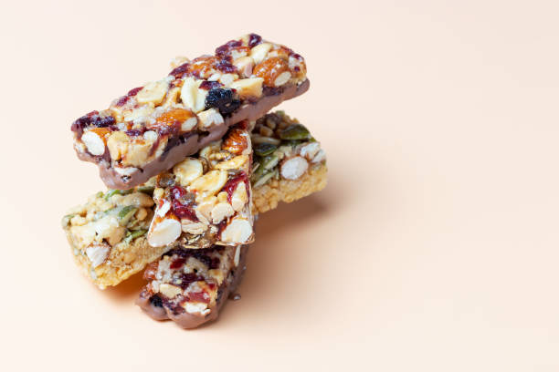 Stack of protein bars close-up on brown background copy space. stock photo