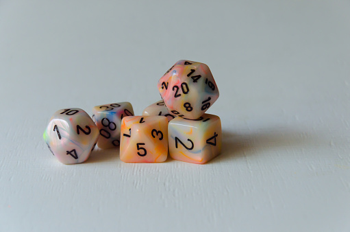 Stack of role playing game dice on white background