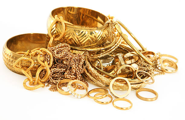 Stack of Scrap Gold Scrap gold chains, rings, and other jewellery on white background gold jewelry stock pictures, royalty-free photos & images
