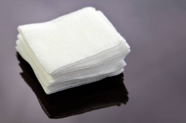 Stack of sterile gauze pad on dark background. stock photo