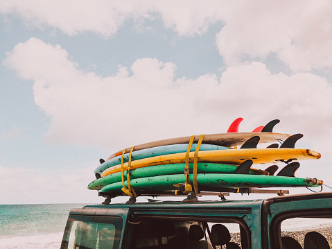 Stack of surfboards on a van roof // mobile stock photo, made with iPhone 8