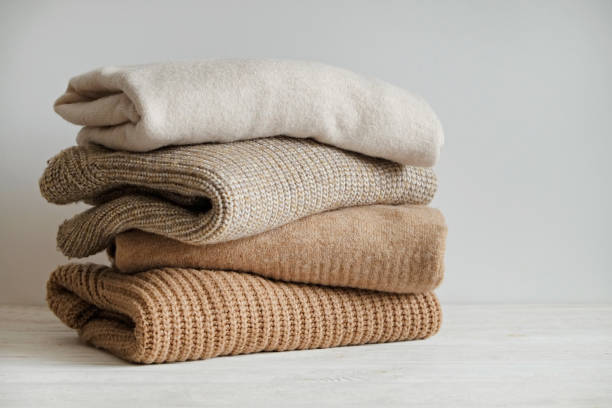 Stack of three sweaters stock photo