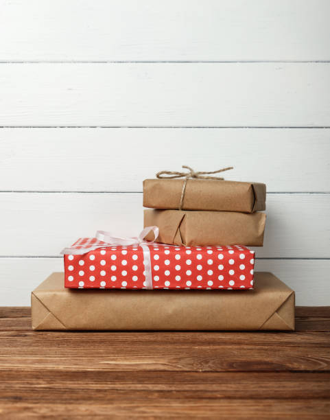 Stack of wrapped gifts on table stock photo