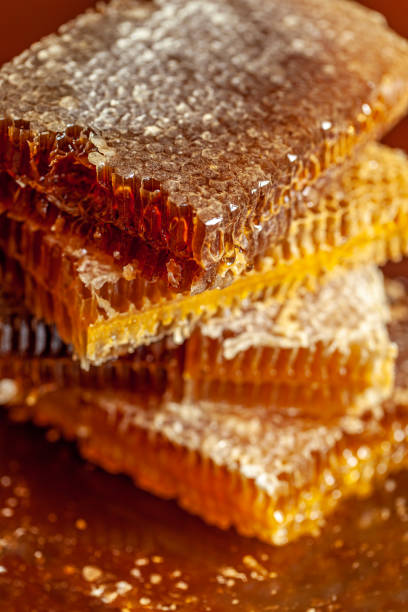 stacked honeycomb pieces dripping stock photo