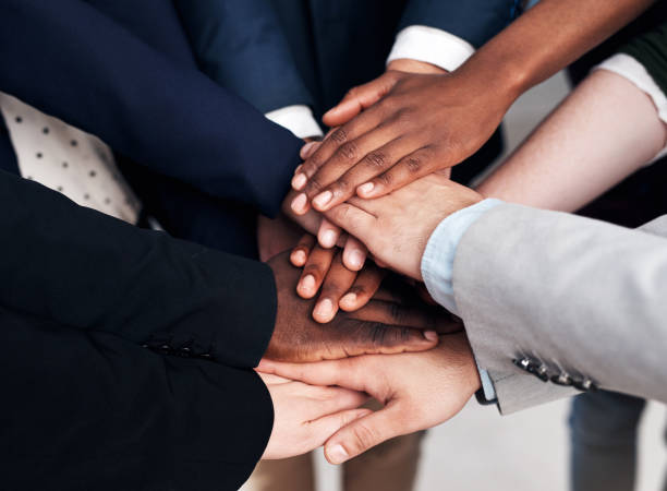 Stacking up the business points Cropped shot of a group of businesspeople joining their hands in solidarity transparent stock pictures, royalty-free photos & images
