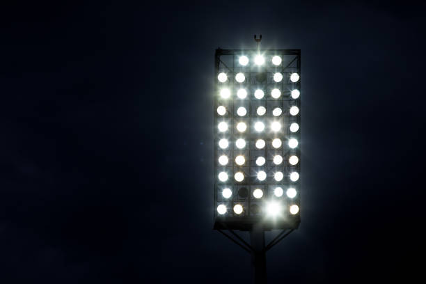 Stadium lights against dark night sky background stock photo