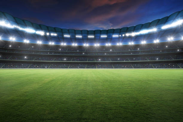Stadium Stadium with spotlight and empty green grass. NIght scene . sports field stock pictures, royalty-free photos & images