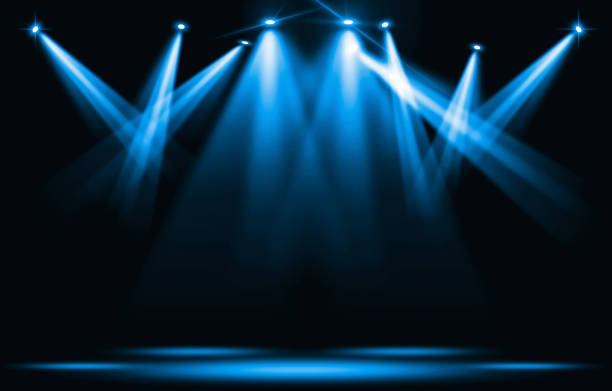 Stage lights. Blue spotlight strike through the darkness. stock photo