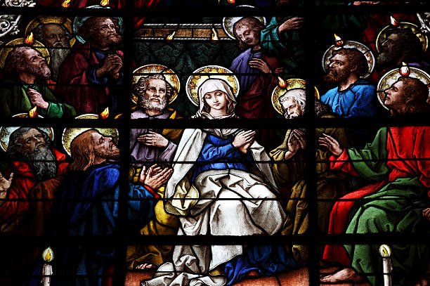 Stained Glass showing pentecost scene Stained Glass showing pentecost scene from the SXV-XVI from la Giralda, the Cathedral of Seville, the biggest Gothic Church of the World and fourth  largest chirstian church in the world, named by UNESCO World Heritage site. seville cathedral stock pictures, royalty-free photos & images
