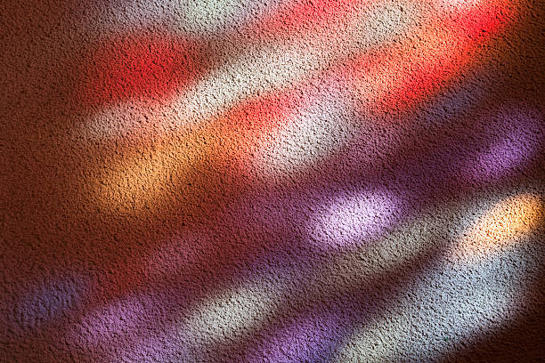 Stained glass window light patches on a church wall stock photo