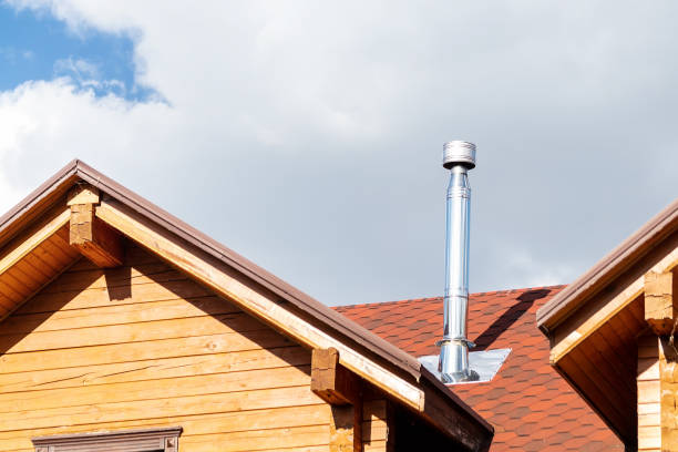 Stainless steel chimney pipe on roof of modern wooden beam cottage villa house. Home fireplace and heating exhaust system Stainless steel chimney pipe on roof of modern wooden beam cottage villa house. Home fireplace and heating exhaust system. chimney stock pictures, royalty-free photos & images