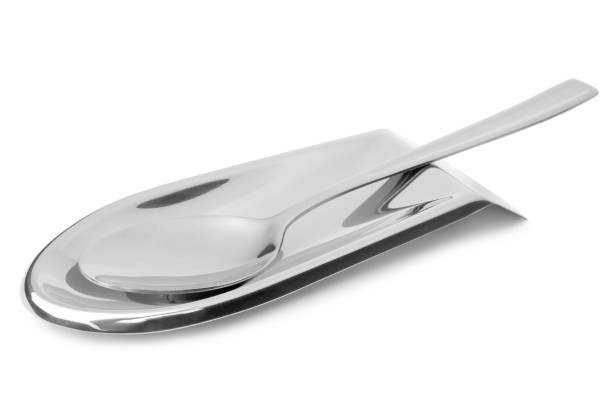 Stainless steel spoon rest and spoon stock photo
