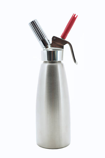 Stainless Steel Whipped Cream Dispenser Gourmet kitchen equpiment in brushed stainless steel on white siphon stock pictures, royalty-free photos & images