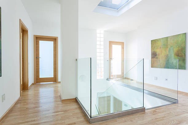 Stairs, glass banister and doors in modern hallway Stairs, glass banister and doors in modern hallway on the attic bannister stock pictures, royalty-free photos & images