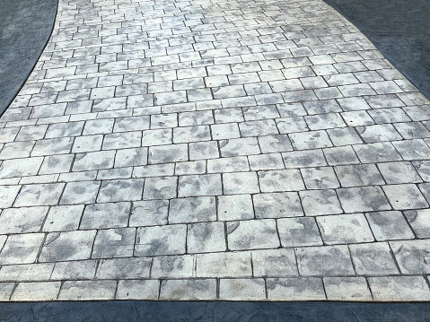Section of stamped impressed concrete floor for driveways and paths