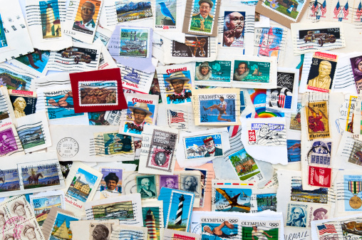 Collection of used U.S. stamps spanning several decades of U.S. postal history. Torn from envelopes.