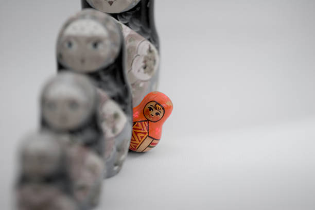 Stand out from the crowd Colored Russian puppet, standing in a queue, peeping. russian nesting doll stock pictures, royalty-free photos & images