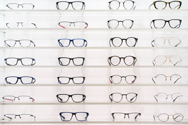 Stand with glasses in the store of optics. Stand with glasses in the store of optics, eye concept. Close-up many glasses on a stand. optical instrument stock pictures, royalty-free photos & images