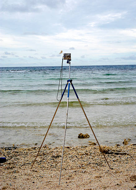 Standing camera on the sandy beach stock photo