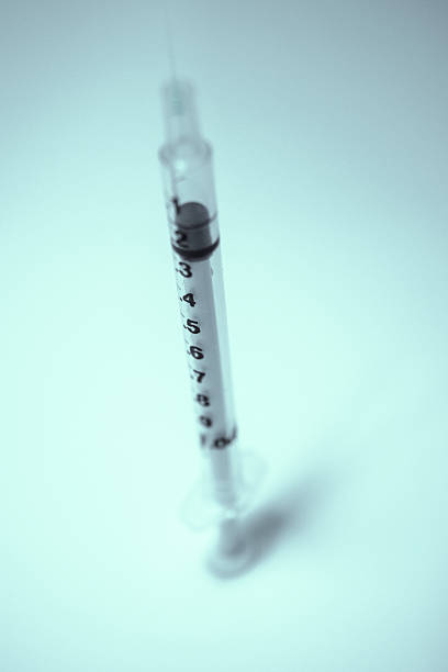 Standing syringe stock photo