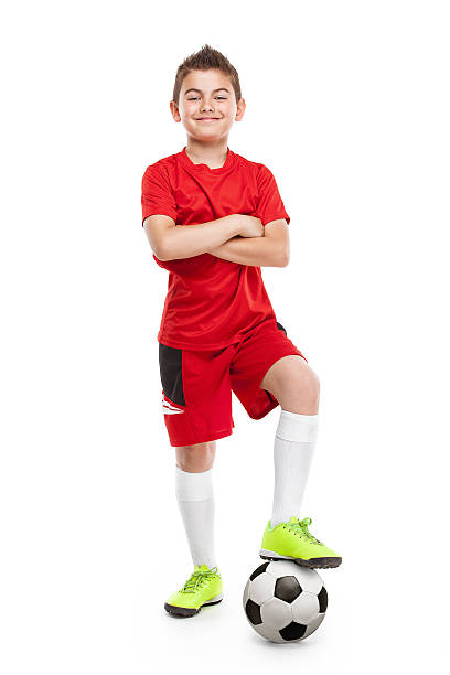 standing young soccer player with football - boys football boots 個照片及圖片檔