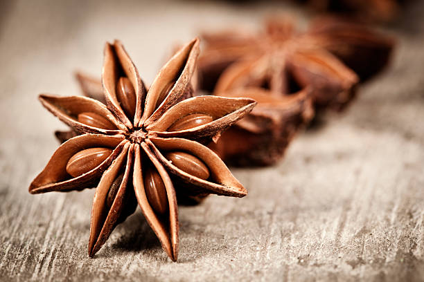 Star Anise Star anise exotic spice on a old wooden table anise stock pictures, royalty-free photos & images