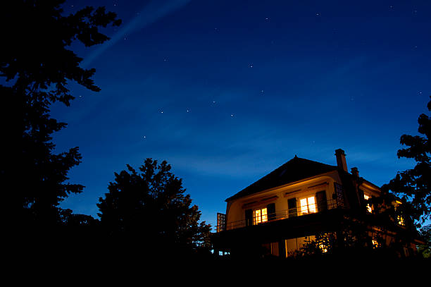 Starry night The constellation of The Plough appears in the sky as the sun sets. Other stars come out too whilst, beneath them, the lights of a house glow warmly. night stock pictures, royalty-free photos & images