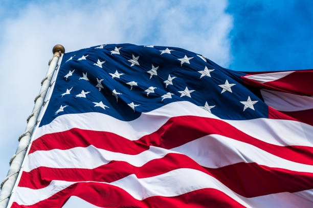 Stars and Stripes on American Flag Stars and Stripes on American Flag with clouds passing in the background close up on the top corner of the flag istock images stock pictures, royalty-free photos & images