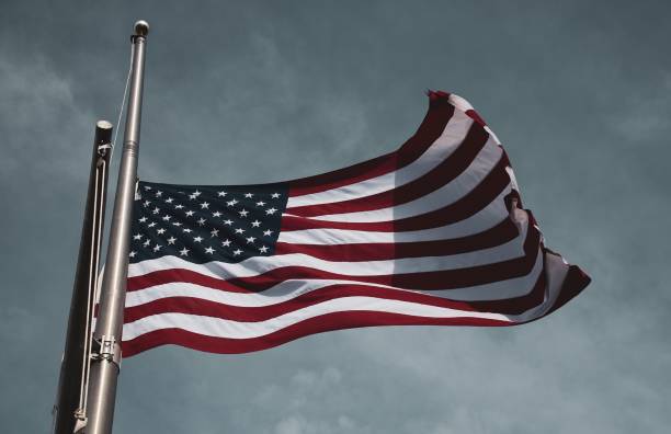 Stars and Stripes American flag flying at half staff in February. flag at half staff stock pictures, royalty-free photos & images