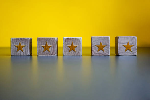 5 stars assessment on wood block. stock photo