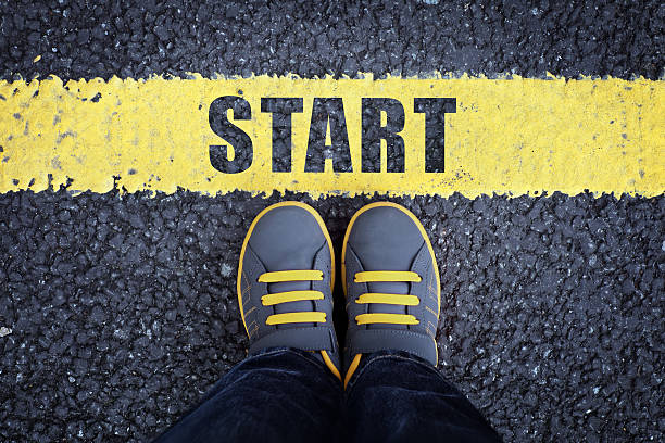 Start line Start line child in sneakers standing next to a yellow starting line resume stock pictures, royalty-free photos & images