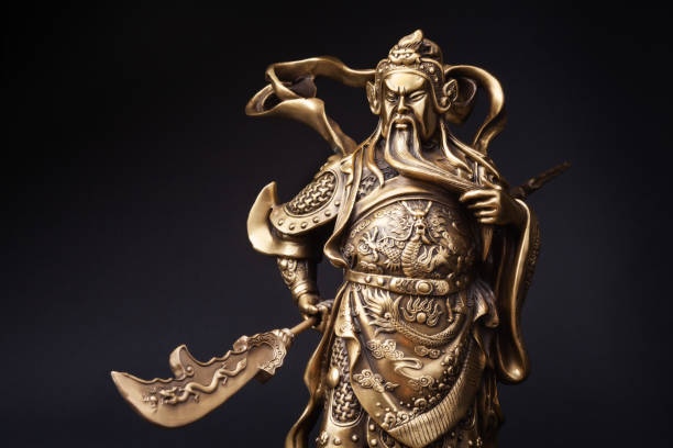 Statue of Kwnao Guanyu on black background The statue of Kwnao Guanyu of the goddess of integrity of China on black background. Kwnao fighter with long beard in the history of China armour of god stock pictures, royalty-free photos & images