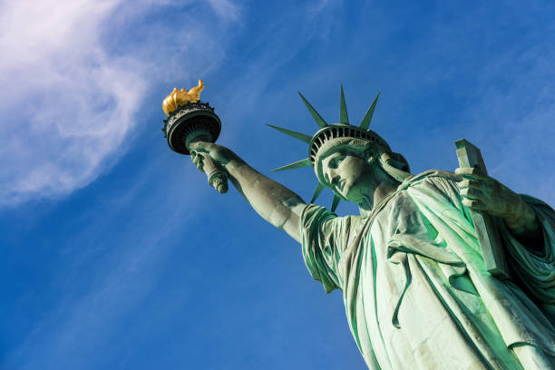 Statue of Liberty against blue sky in New York City stock photo