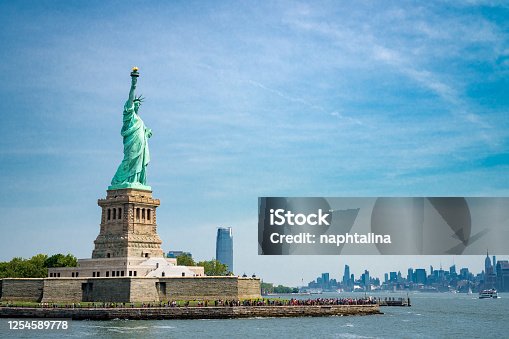 istock Statue of liberty and Liberty Island by day 1254589778