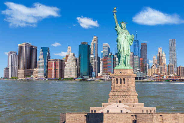 Statue of Liberty and New York City Skyline with Manhattan Financial District and World Trade Center. stock photo