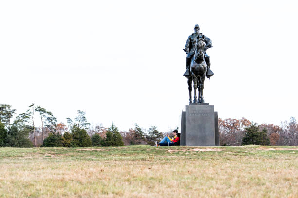 Statue of Stonewall Jackson and many tourists people sitting in National Battlefield Park in Virginia where Bull Run battle was fought Manassas, USA - November 25, 2017: Statue of Stonewall Jackson and many tourists people sitting in National Battlefield Park in Virginia where Bull Run battle was fought stonewall jackson stock pictures, royalty-free photos & images