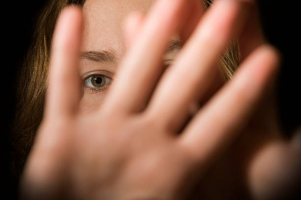 Stay Away! A woman's hands in front of her face. domestic violence stock pictures, royalty-free photos & images
