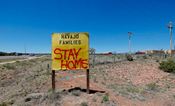 COVID-19 stay home sign on Navajo Nation A sign along a road in St. Michaels, Arizona, in the Navajo Nation encourages people to stay at home during the COVID-19 pandemic. Taken May 5, 2020. navajo nation covid stock pictures, royalty-free photos & images