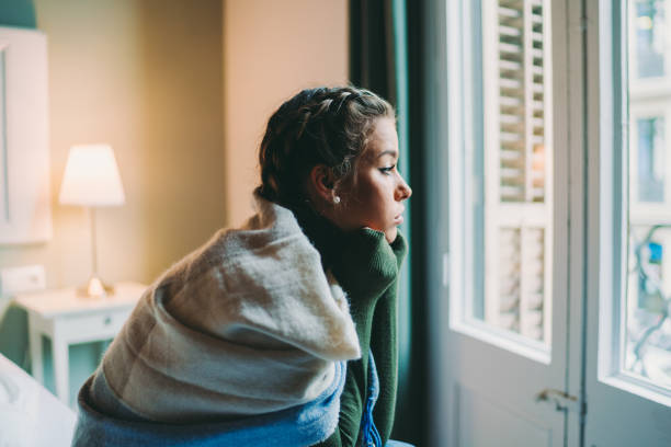 Stay home, stay safe during COVID-19 pandemic Woman staying home for safety during coronavirus pandemic one young woman only stock pictures, royalty-free photos & images