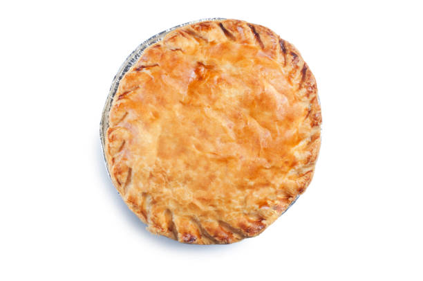 Steak Pie Overhead view of a single cooked meat pie complete with foil packaging cut out against a white background. meat pie stock pictures, royalty-free photos & images