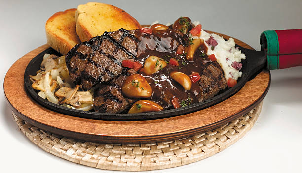 steak served with garnishes stock photo