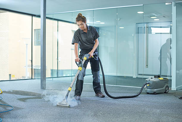 steam cleaning the office carpet a male cleaning contractor steam cleans an office carpet in a empty office in between tenants. cleaner stock pictures, royalty-free photos & images