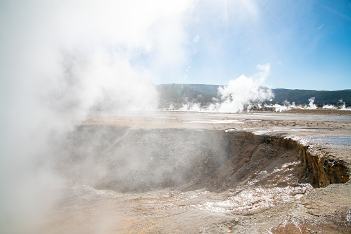 Steam rising up out of geysers pools and craters in Yellowstone National Park in Wyoming near Montana in the United States of America (USA).