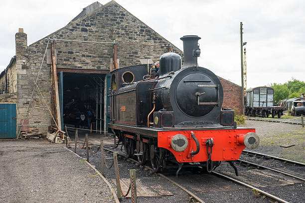 Steam train outside shed stock photo