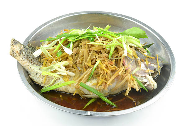 Steamed fish with soy sauce  isolated on a white background stock photo