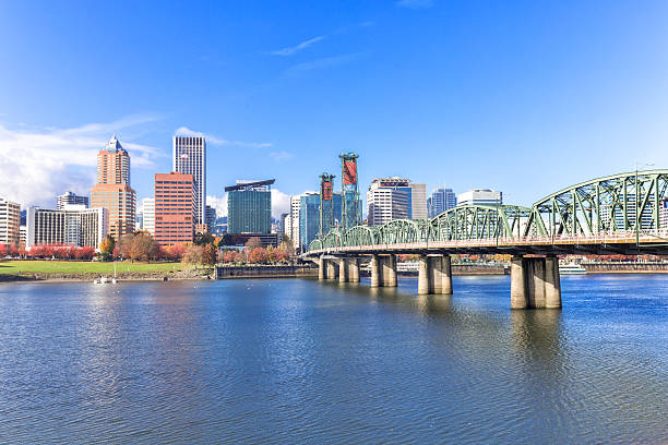 steel bridge over water with cityscape and skyline in portland stock photo